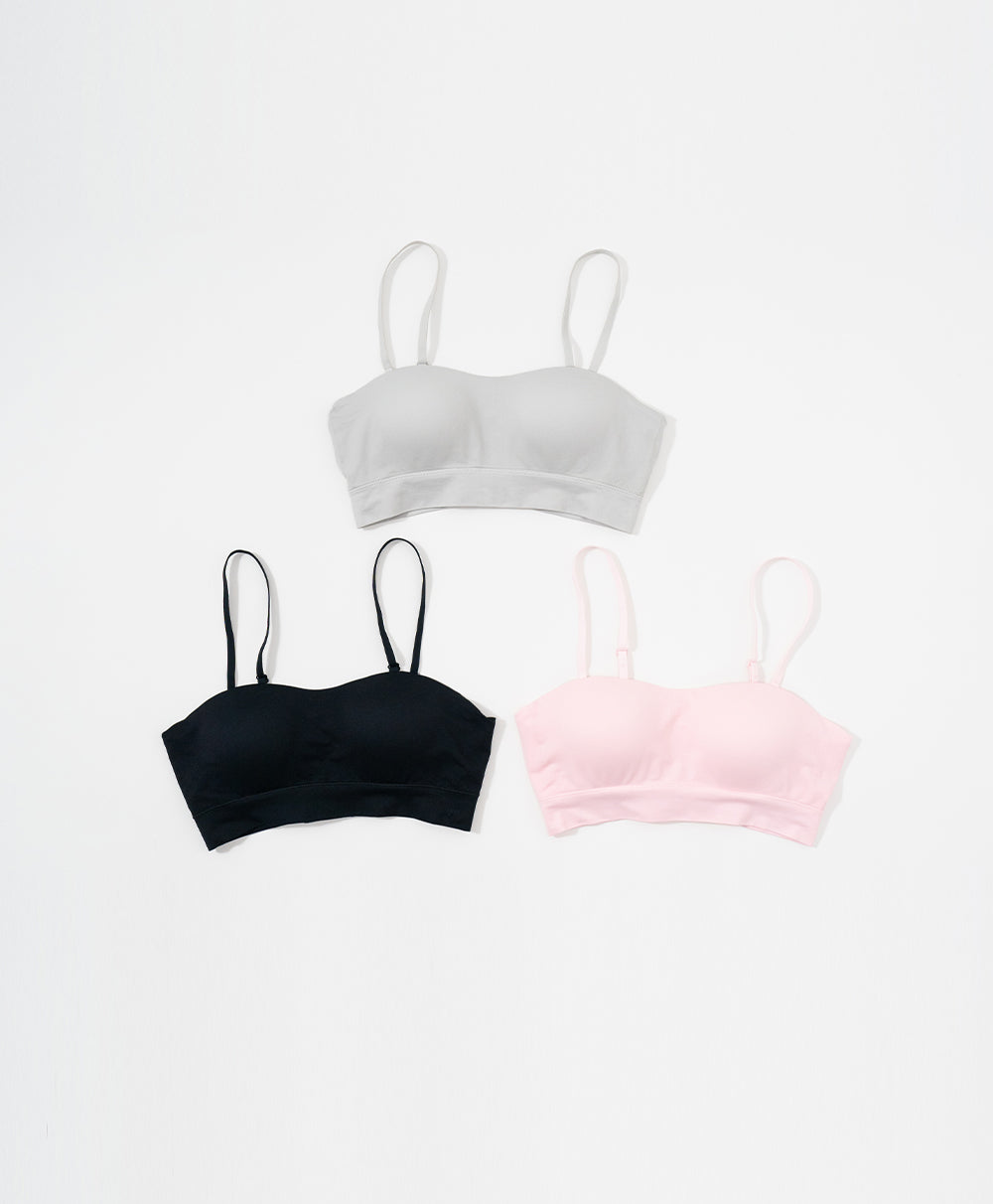 Three Sports bras in white, black, and pink