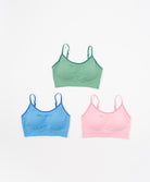 Three sports bras in green, blue, and pink .