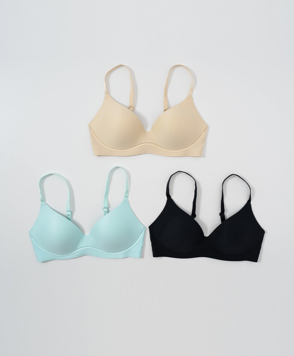 Three bras in beige, light blue, and black on a white background