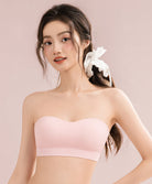 Woman wearing a light pink strapless Sports Bra