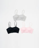 Three Sports bras in white, black, and pink 